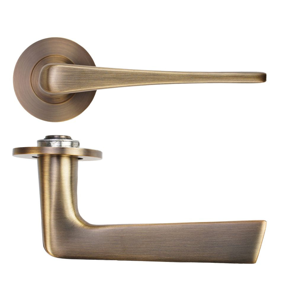 High quality image of the Rosso Tecnica - Como Lever on 4mm Round Slim Sprung Rose - Antique Brass | Sku. RT020-SLIM-AB | available to order from Trade Door Handles.