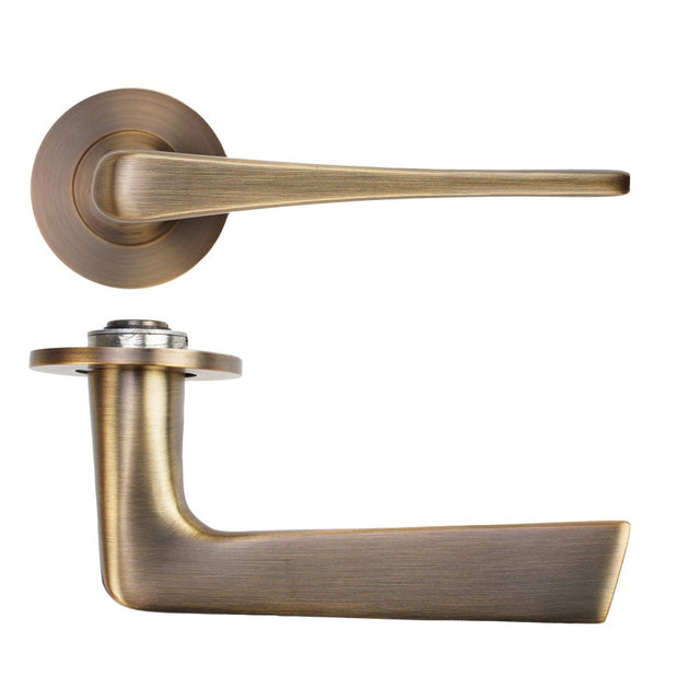 High quality image of the Rosso Tecnica - Como Lever on 4mm Round Slim Sprung Rose - Antique Brass | Sku. RT020-SLIM-AB | available to order from Trade Door Handles.