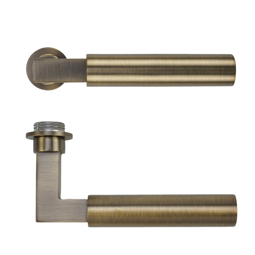 High quality image of the Rosso Tecnica - Garda Lever on 32mm Round Mini Rose - Antique Brass | Sku. RT050-MINI-AB | available to order from Trade Door Handles.