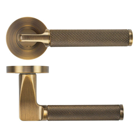 High quality image of the STANZA - Bilbao Lever on Rose - Antique Brass | Sku. ZPA090-AB | available to order from Trade Door Handles.