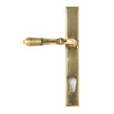 This is an image showing From The Anvil - Aged Brass Reeded Slimline Lever Espag. Lock Set available from trade door handles, quick delivery and discounted prices