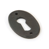 This is an image showing From The Anvil - Beeswax Oval Escutcheon available from trade door handles, quick delivery and discounted prices