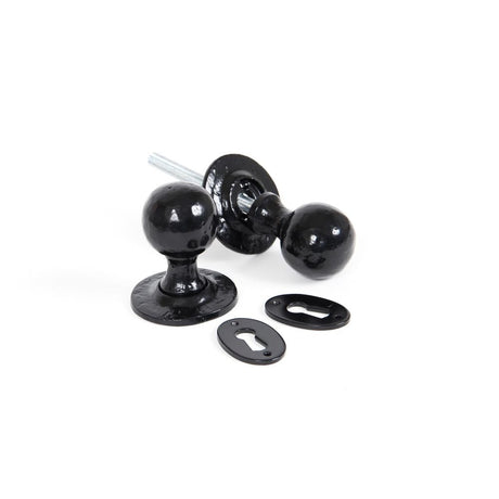 This is an image showing From The Anvil - Black Round Mortice/Rim Knob Set available from trade door handles, quick delivery and discounted prices
