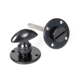 This is an image showing From The Anvil - Black Round Bathroom Thumbturn available from trade door handles, quick delivery and discounted prices