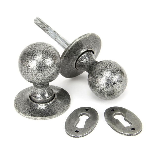 This is an image showing From The Anvil - Pewter Round Mortice/Rim Knob Set available from trade door handles, quick delivery and discounted prices