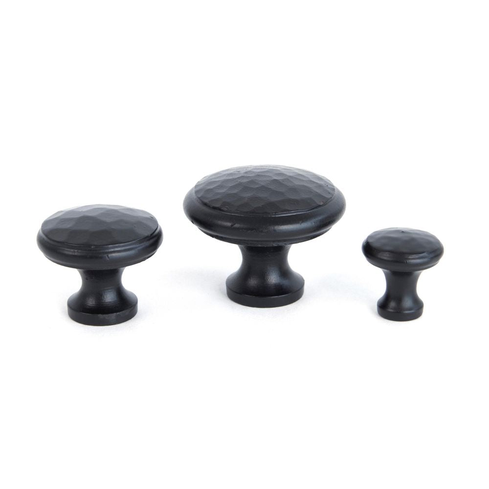 This is an image showing From The Anvil - Black Hammered Cabinet Knob - Large available from trade door handles, quick delivery and discounted prices