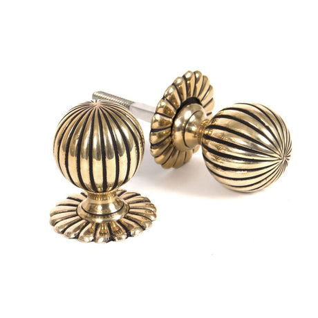 This is an image showing From The Anvil - Aged Brass Flower Mortice/Rim Knob Set available from trade door handles, quick delivery and discounted prices