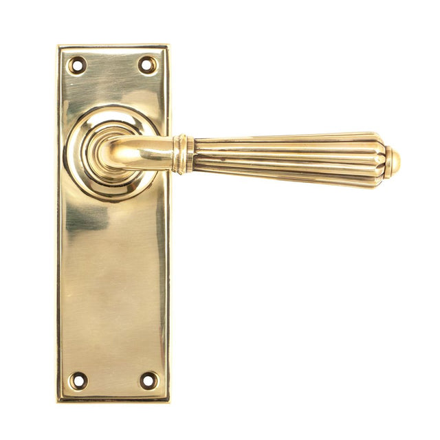 This is an image showing From The Anvil - Aged Brass Hinton Lever Latch Set available from trade door handles, quick delivery and discounted prices