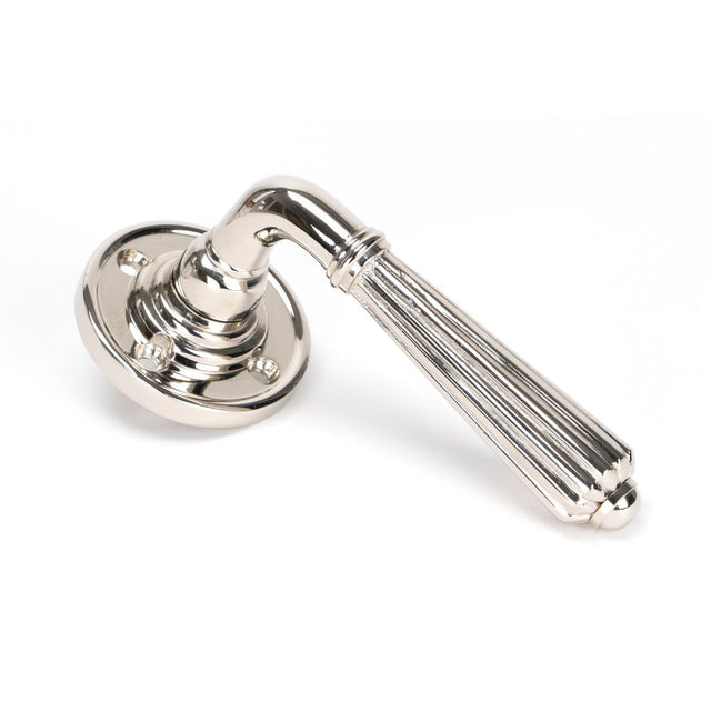 This is an image showing From The Anvil - Polished Nickel Hinton Lever on Rose Set available from trade door handles, quick delivery and discounted prices