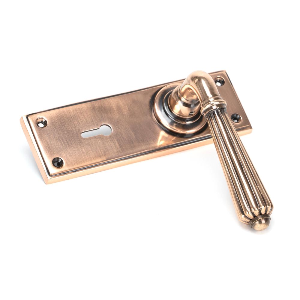 This is an image showing From The Anvil - Polished Bronze Hinton Lever Lock Set available from trade door handles, quick delivery and discounted prices