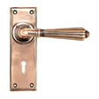 This is an image showing From The Anvil - Polished Bronze Hinton Lever Lock Set available from trade door handles, quick delivery and discounted prices