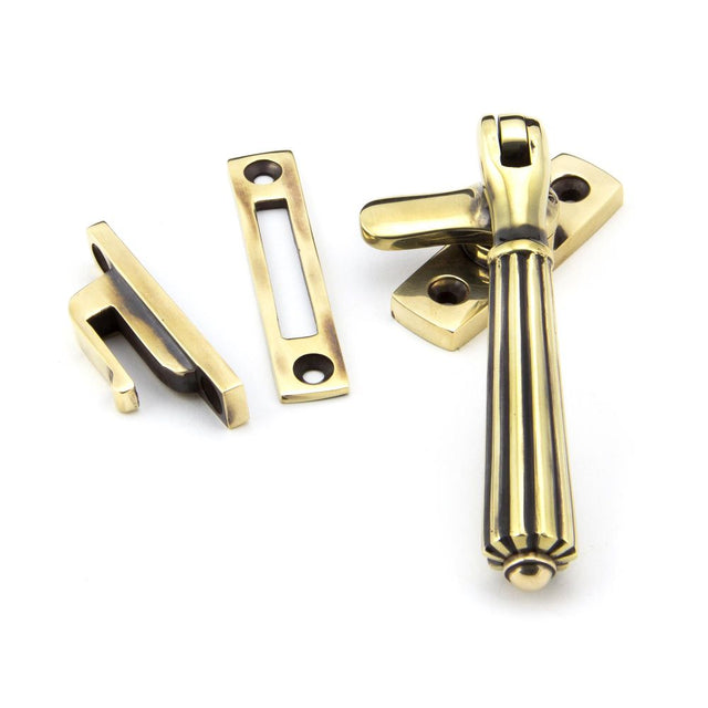This is an image showing From The Anvil - Aged Brass Locking Hinton Fastener available from trade door handles, quick delivery and discounted prices