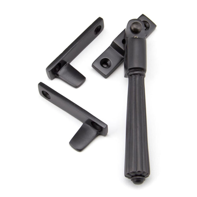 This is an image showing From The Anvil - Aged Bronze Night-Vent Locking Hinton Fastener available from trade door handles, quick delivery and discounted prices