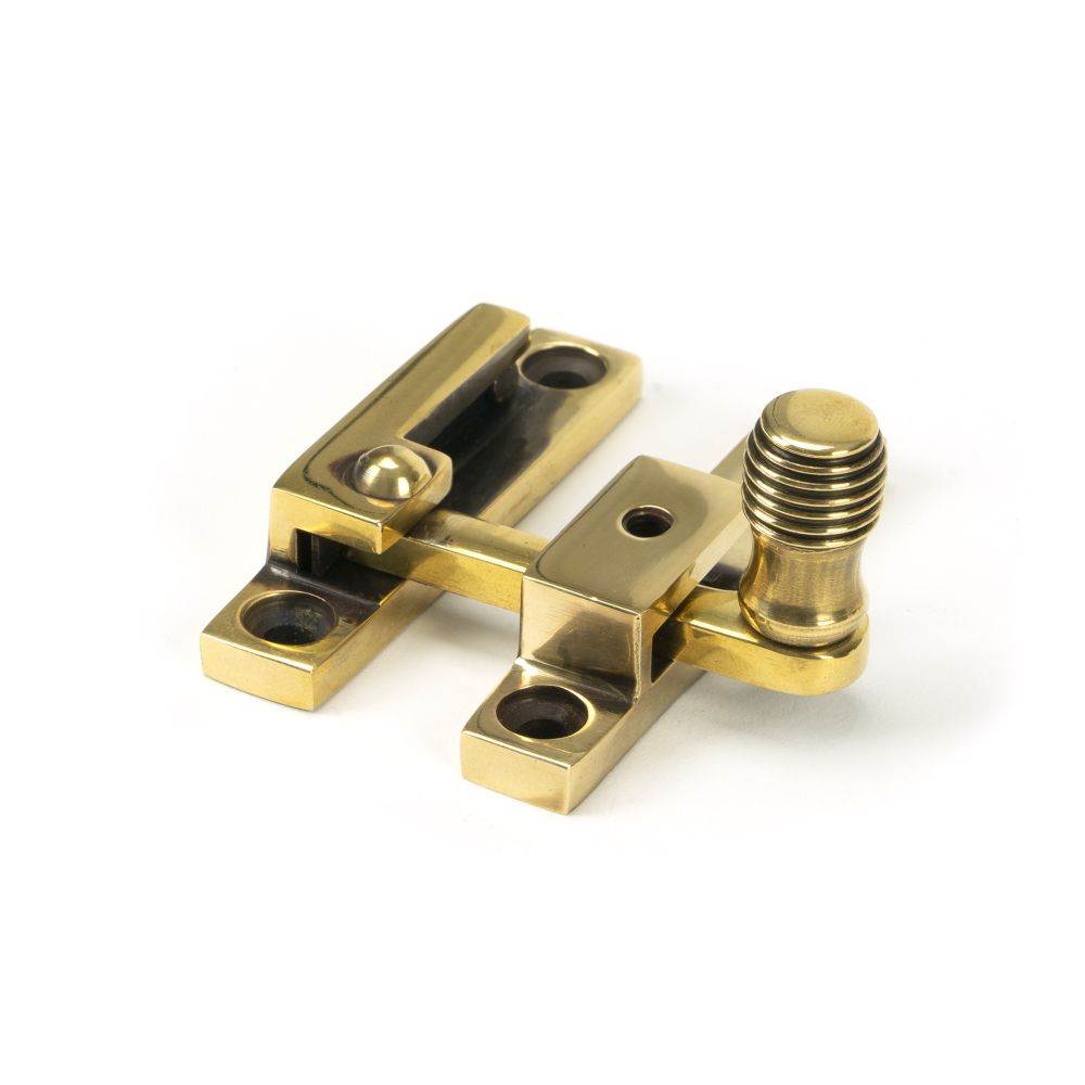 This is an image showing From The Anvil - Aged Brass Beehive Quadrant Fastener - Narrow available from trade door handles, quick delivery and discounted prices