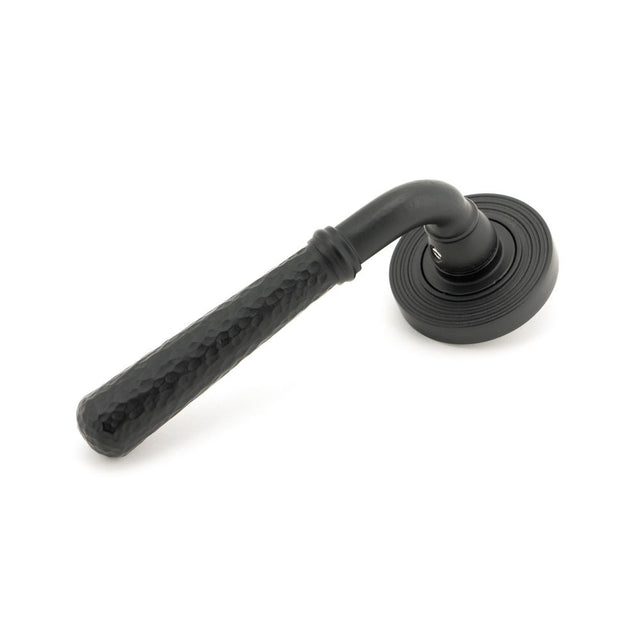 This is an image showing From The Anvil - Matt Black Hammered Newbury Lever on Rose Set (Beehive) available from trade door handles, quick delivery and discounted prices