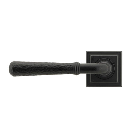 This is an image showing From The Anvil - Matt Black Hammered Newbury Lever on Rose Set (Square) available from trade door handles, quick delivery and discounted prices