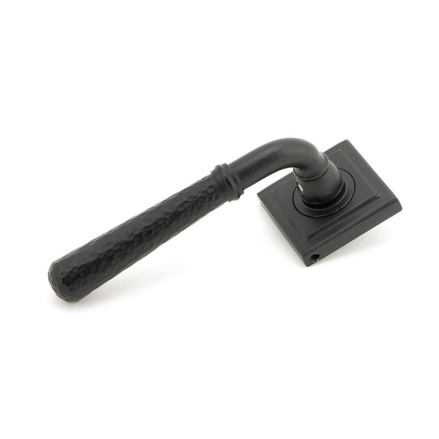 This is an image showing From The Anvil - Matt Black Hammered Newbury Lever on Rose Set (Square) available from trade door handles, quick delivery and discounted prices