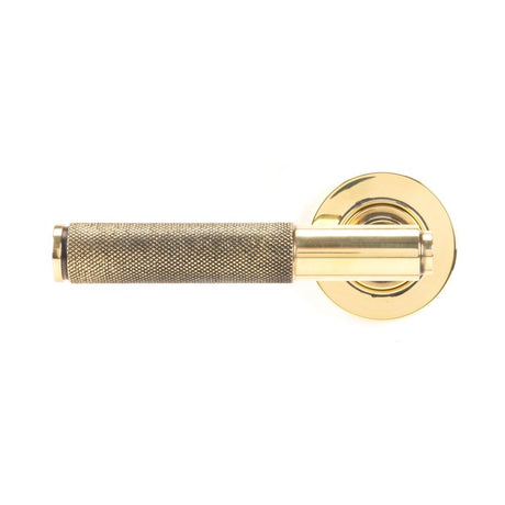 This is an image showing From The Anvil - Aged Brass Brompton Lever on Rose Set (Plain) available from trade door handles, quick delivery and discounted prices