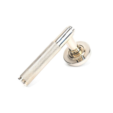 This is an image showing From The Anvil - Polished Nickel Brompton Lever on Rose Set (Plain) available from trade door handles, quick delivery and discounted prices