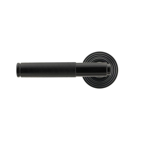 This is an image showing From The Anvil - Black Brompton Lever on Rose Set (Beehive) available from trade door handles, quick delivery and discounted prices