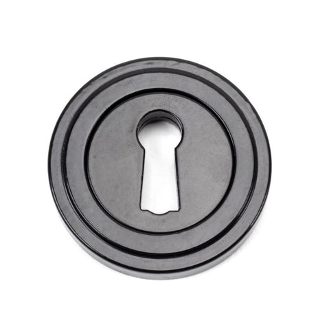 This is an image showing From The Anvil - Black Round Escutcheon (Art Deco) available from trade door handles, quick delivery and discounted prices