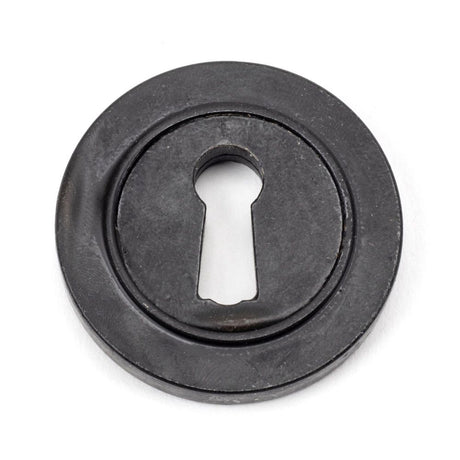 This is an image showing From The Anvil - External Beeswax Round Escutcheon (Plain) available from trade door handles, quick delivery and discounted prices