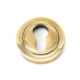 This is an image showing From The Anvil - Aged Brass Round Euro Escutcheon (Plain) available from trade door handles, quick delivery and discounted prices