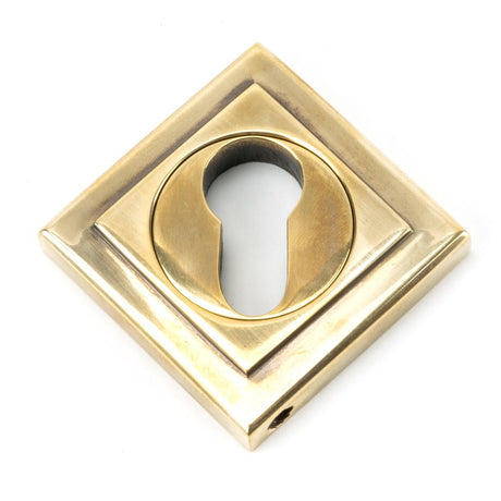 This is an image showing From The Anvil - Aged Brass Round Euro Escutcheon (Square) available from trade door handles, quick delivery and discounted prices