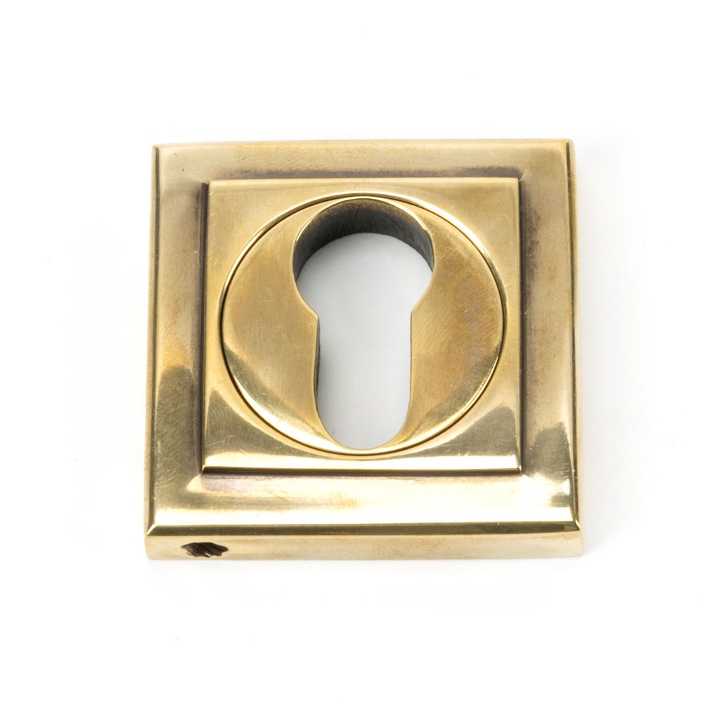 This is an image showing From The Anvil - Aged Brass Round Euro Escutcheon (Square) available from trade door handles, quick delivery and discounted prices