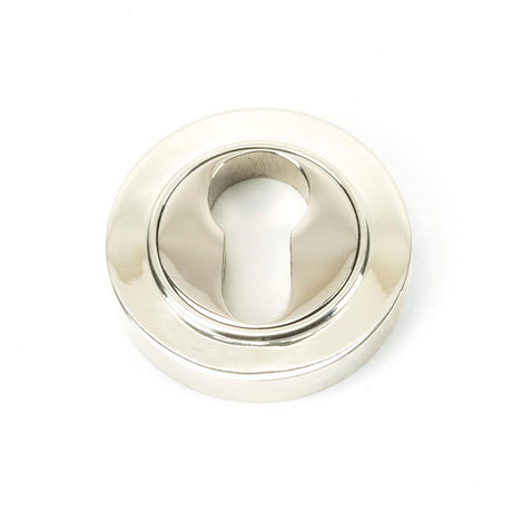 This is an image showing From The Anvil - Polished Nickel Round Euro Escutcheon (Plain) available from trade door handles, quick delivery and discounted prices