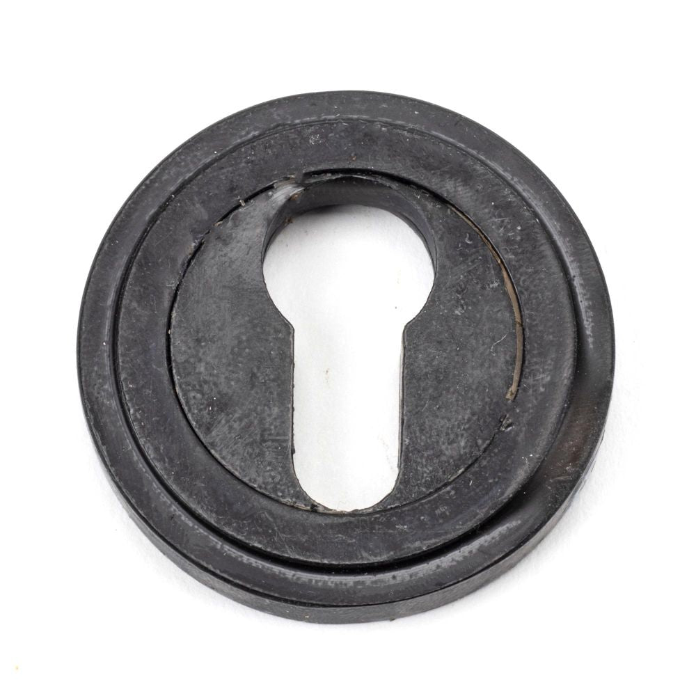 This is an image showing From The Anvil - External Beeswax Round Euro Escutcheon (Art Deco) available from trade door handles, quick delivery and discounted prices