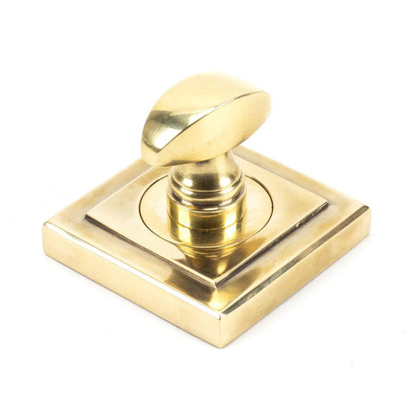 This is an image showing From The Anvil - Aged Brass Round Thumbturn Set (Square) available from trade door handles, quick delivery and discounted prices