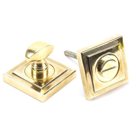 This is an image showing From The Anvil - Aged Brass Round Thumbturn Set (Square) available from trade door handles, quick delivery and discounted prices