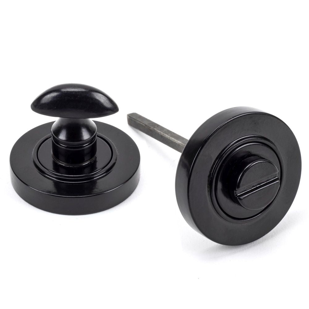 This is an image showing From The Anvil - Black Round Thumbturn Set (Plain) available from trade door handles, quick delivery and discounted prices