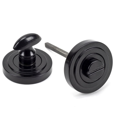 This is an image showing From The Anvil - Black Round Thumbturn Set (Art Deco) available from trade door handles, quick delivery and discounted prices