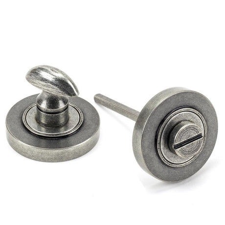 This is an image showing From The Anvil - Pewter Round Thumbturn Set (Plain) available from trade door handles, quick delivery and discounted prices