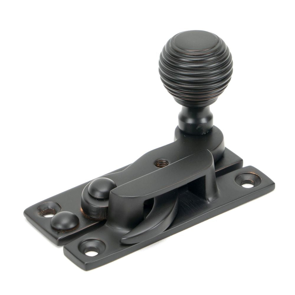 This is an image showing From The Anvil - Aged Bronze Beehive Sash Hook Fastener available from trade door handles, quick delivery and discounted prices