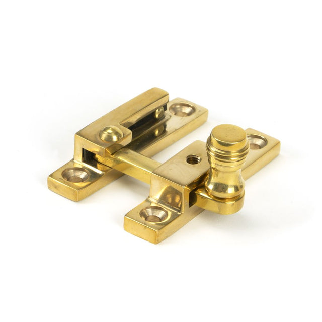 This is an image showing From The Anvil - Polished Brass Prestbury Quadrant Fastener - Narrow available from trade door handles, quick delivery and discounted prices