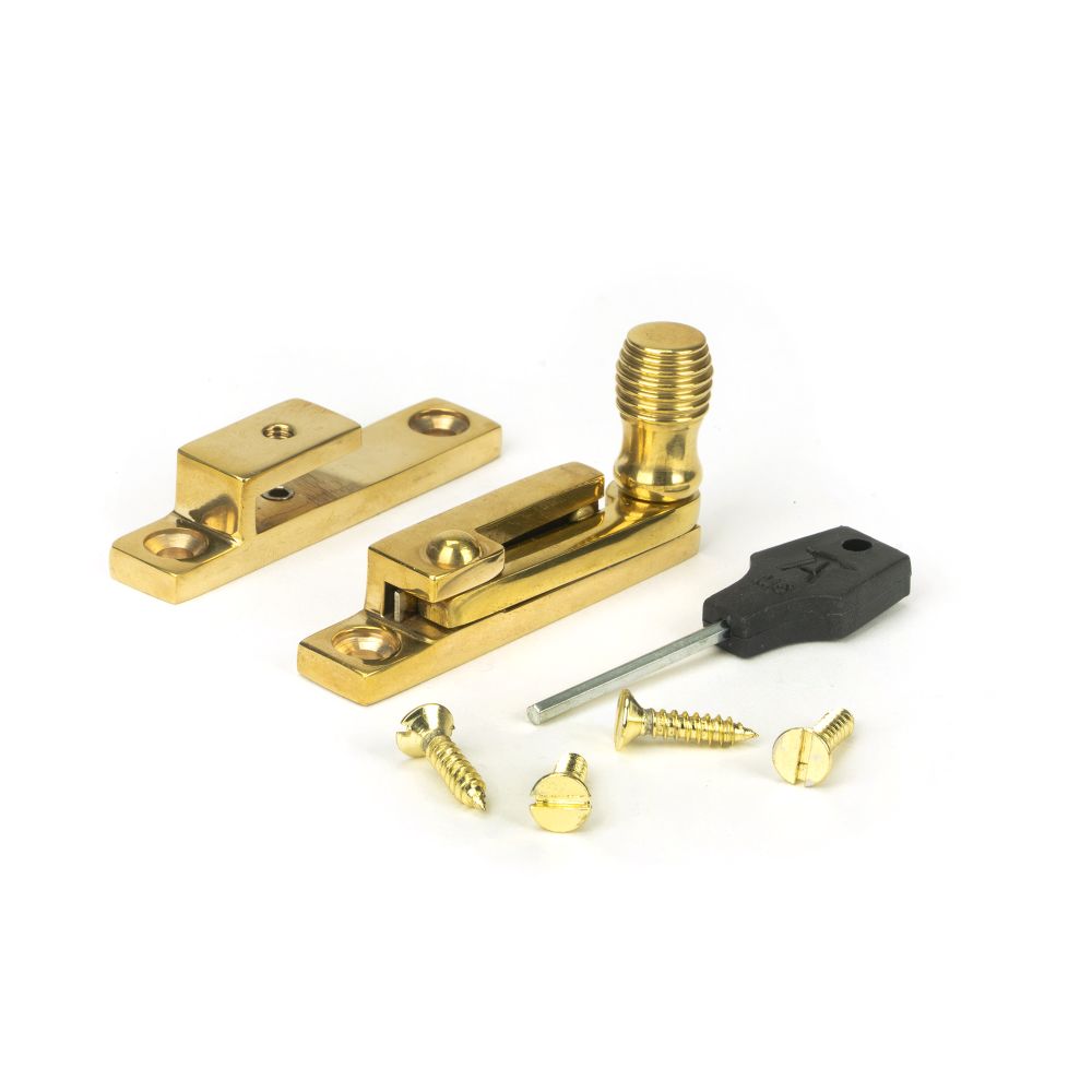 This is an image showing From The Anvil - Polished Brass Beehive Quadrant Fastener - Narrow available from trade door handles, quick delivery and discounted prices