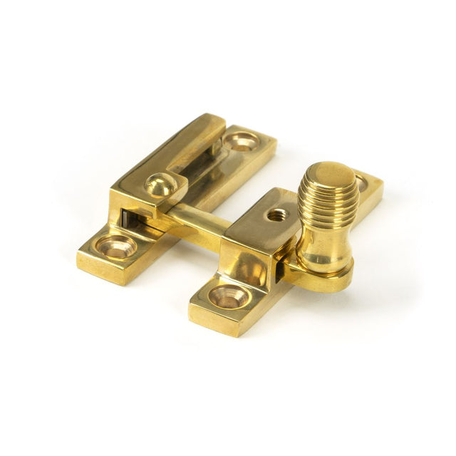 This is an image showing From The Anvil - Polished Brass Beehive Quadrant Fastener - Narrow available from trade door handles, quick delivery and discounted prices