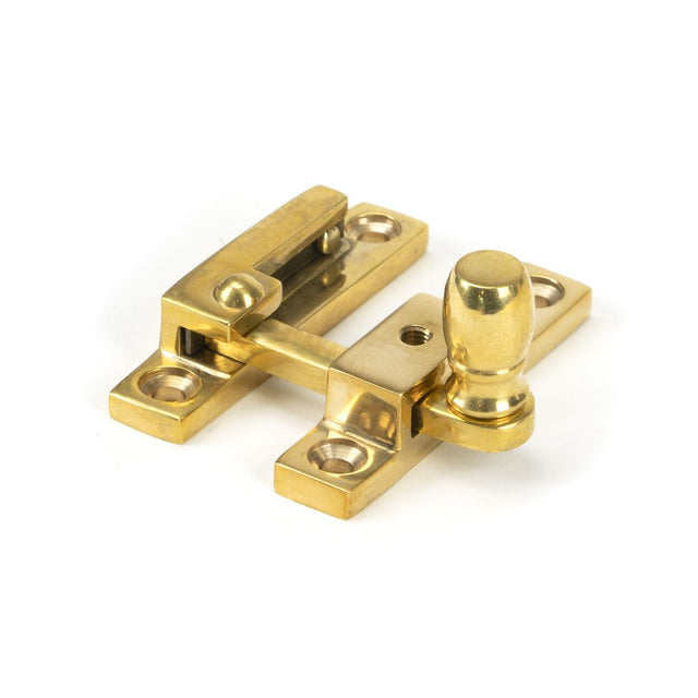 This is an image showing From The Anvil - Polished Brass Mushroom Quadrant Fastener - Narrow available from trade door handles, quick delivery and discounted prices