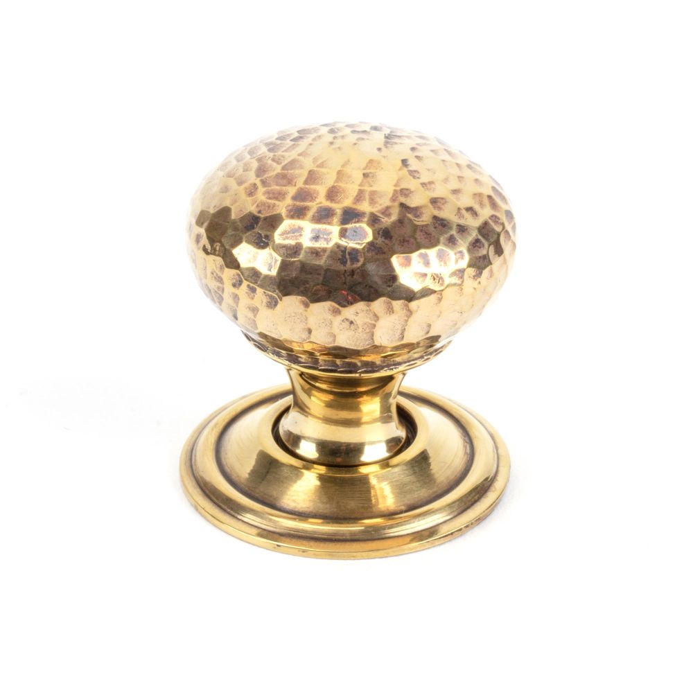 This is an image showing From The Anvil - Aged Brass Hammered Mushroom Cabinet Knob 32mm available from trade door handles, quick delivery and discounted prices