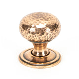 This is an image showing From The Anvil - Polished Bronze Hammered Mushroom Cabinet Knob 32mm available from trade door handles, quick delivery and discounted prices