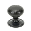 This is an image showing From The Anvil - Aged Bronze Hammered Mushroom Cabinet Knob 38mm available from trade door handles, quick delivery and discounted prices