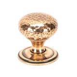 This is an image showing From The Anvil - Polished Bronze Hammered Mushroom Cabinet Knob 38mm available from trade door handles, quick delivery and discounted prices
