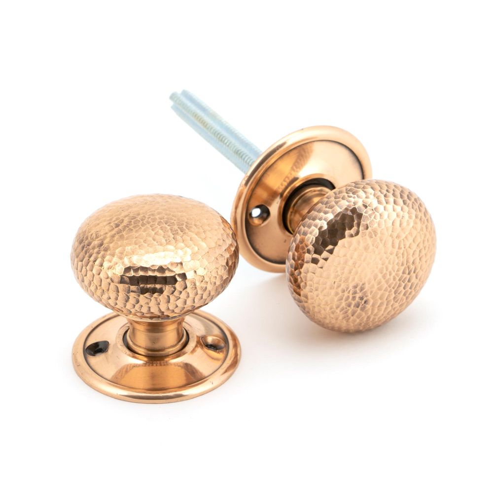 This is an image showing From The Anvil - Polished Bronze Hammered Mushroom Mortice/Rim Knob Set available from trade door handles, quick delivery and discounted prices