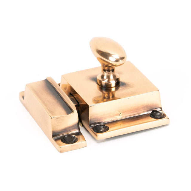 This is an image showing From The Anvil - Polished Bronze Cabinet Latch available from trade door handles, quick delivery and discounted prices