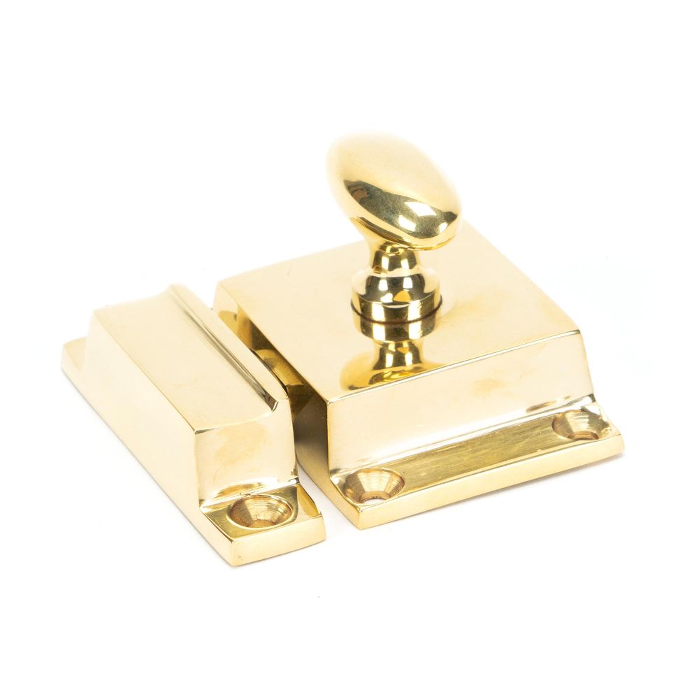 This is an image showing From The Anvil - Polished Brass Cabinet Latch available from trade door handles, quick delivery and discounted prices