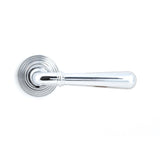 This is an image showing From The Anvil - Polished Chrome Newbury Lever on Rose Set (Beehive) available from trade door handles, quick delivery and discounted prices