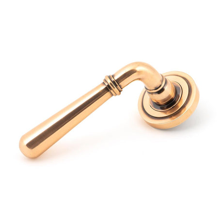 This is an image showing From The Anvil - Polished Bronze Newbury Lever on Rose Set (Art Deco) available from trade door handles, quick delivery and discounted prices